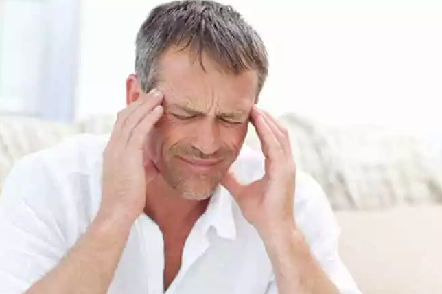 Man in Pain From TMJ Induced Headaches.