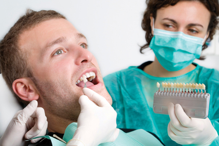 teeth whitening procedure getting done on a patient